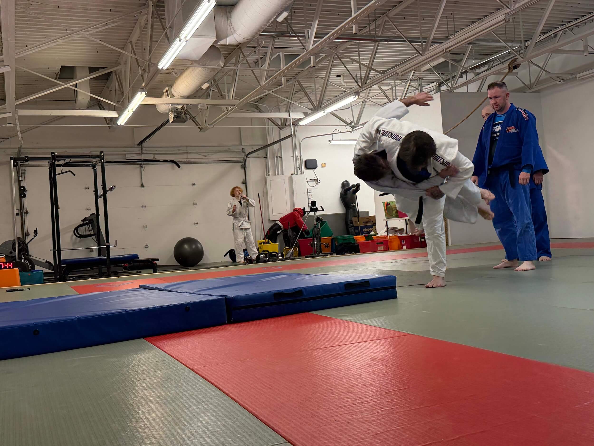 Carmel Judo students practicing flipping competitor during marital arts class.